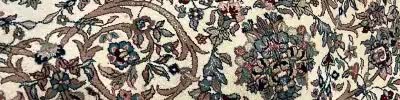 Close detail of a cream floral oriental rug border, from the business's own website
