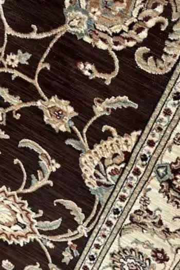 A chocolate-brown floral oriental rug, from the business's own website